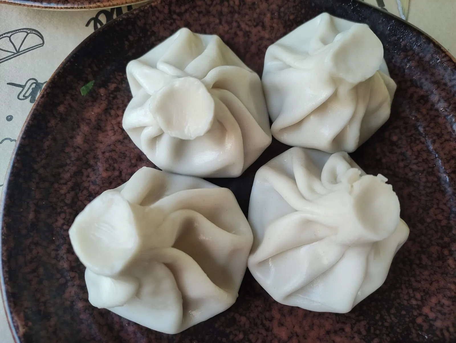 A plate of Georgian khinkali with twisted dough knots