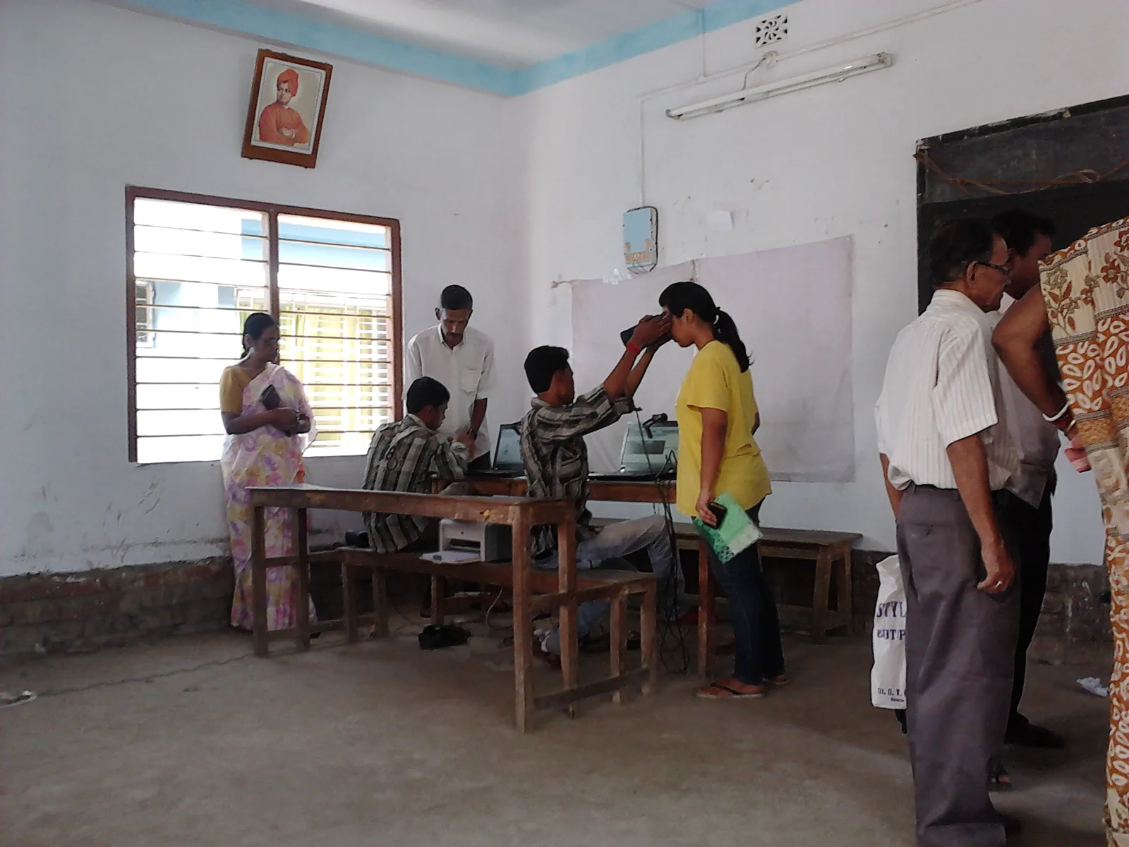 Close-up of a person's fingers being scanned on a biometric fingerprint device during Aadhaar enrolment in Howrah