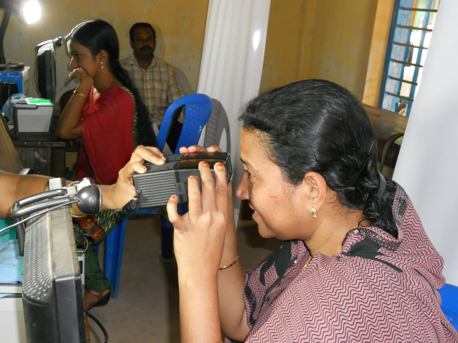 A person looking into a dual iris scanner during Aadhaar biometric capture