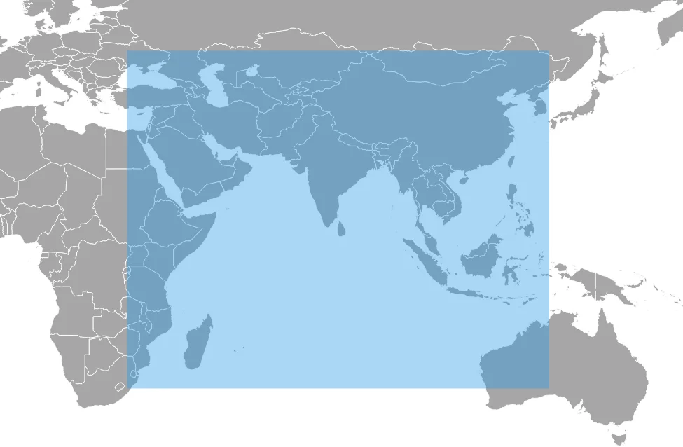 World map with a shaded blue rectangle centred on India showing the NavIC service area, stretching from the eastern Mediterranean and East Africa to western Australia and Japan