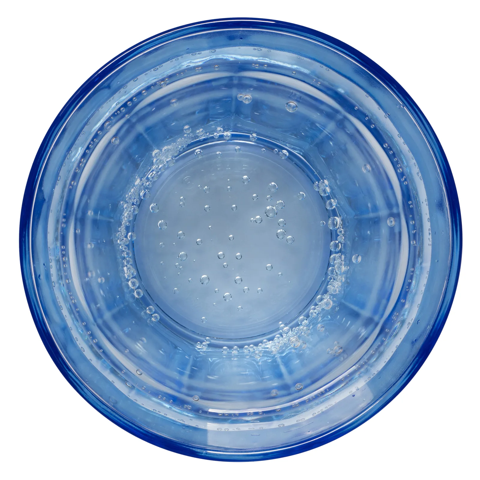 A clear glass of sparkling water against a dark blue background