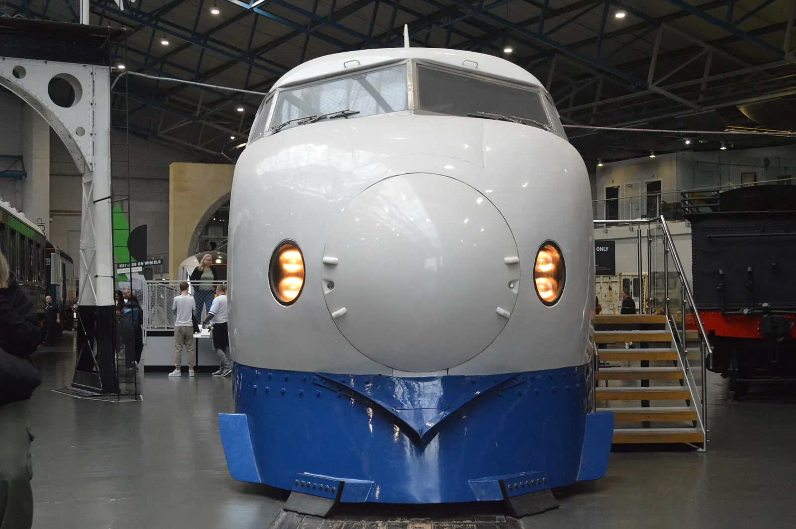 The rounded white-and-blue nose of a 0 Series Shinkansen in a museum