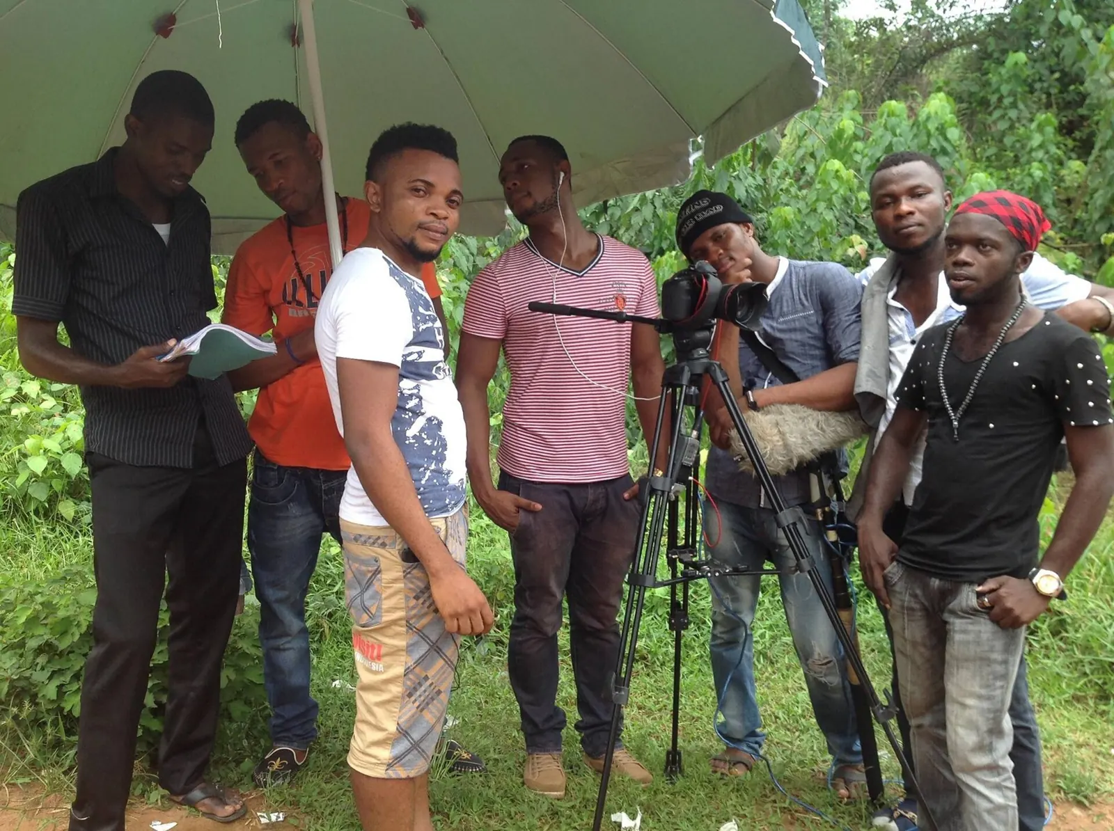 Cast and crew with a camera on tripod filming outdoors in Awka, Nigeria
