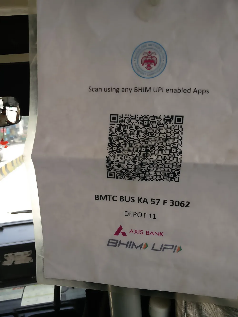 Printed QR code sign inside a Bengaluru city bus inviting passengers to pay using any BHIM UPI app