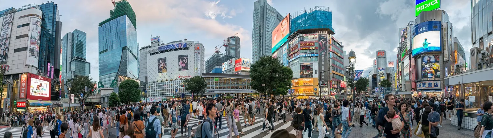 Panorama of crowds crossing the Shibuya scramble crossing in Tokyo