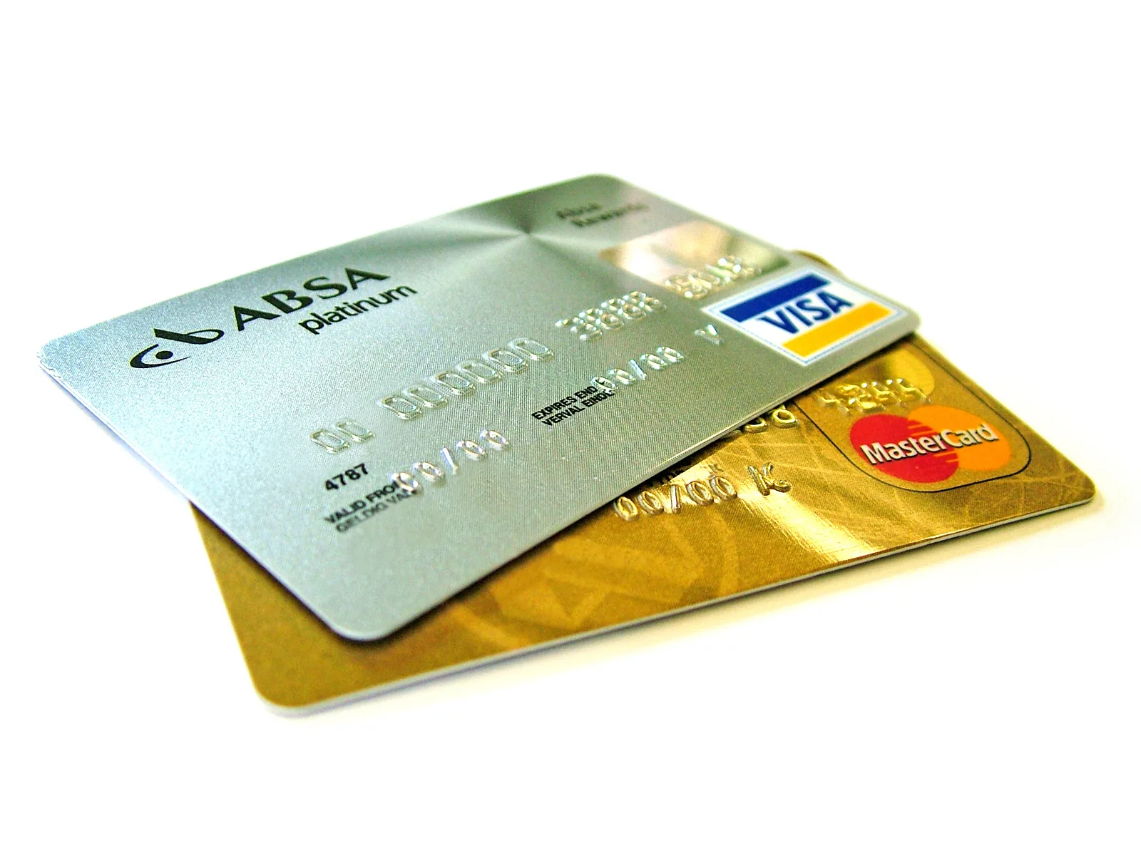 Several plastic credit cards with magnetic stripes fanned out on a surface