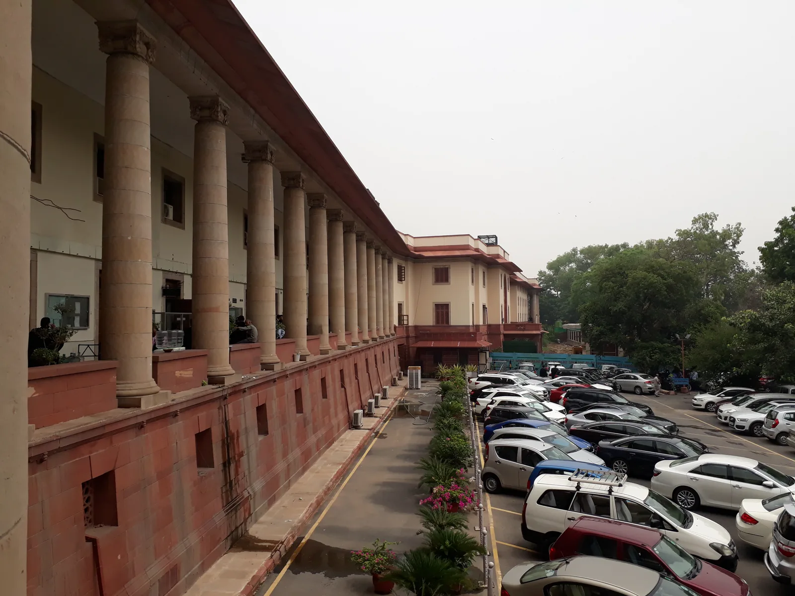 The cream stone facade and lawn of the Supreme Court of India building in New Delhi