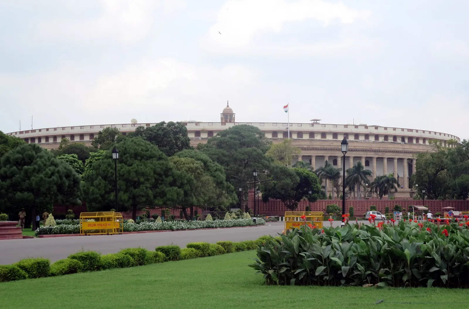 The circular colonnaded Old Parliament House (Sansad Bhavan) in New Delhi seen across green lawns