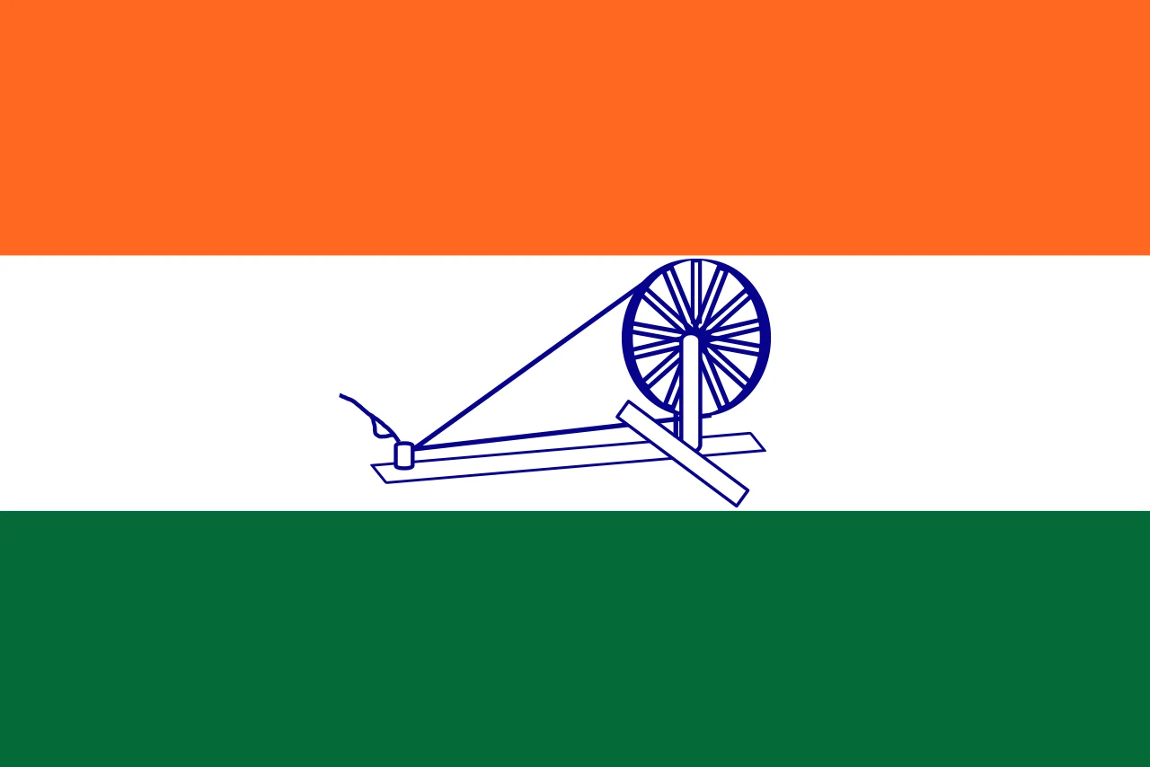 The 1931 Indian National Congress flag: three horizontal bands of saffron, white and green with a blue spinning wheel, or charkha, in the centre of the white band