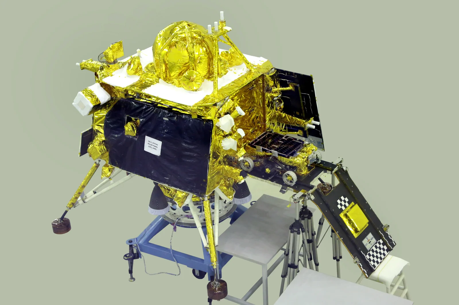Chandrayaan-3 Vikram lander module being prepared in a clean-room, showing its gold thermal blankets, legs and solar panel surfaces