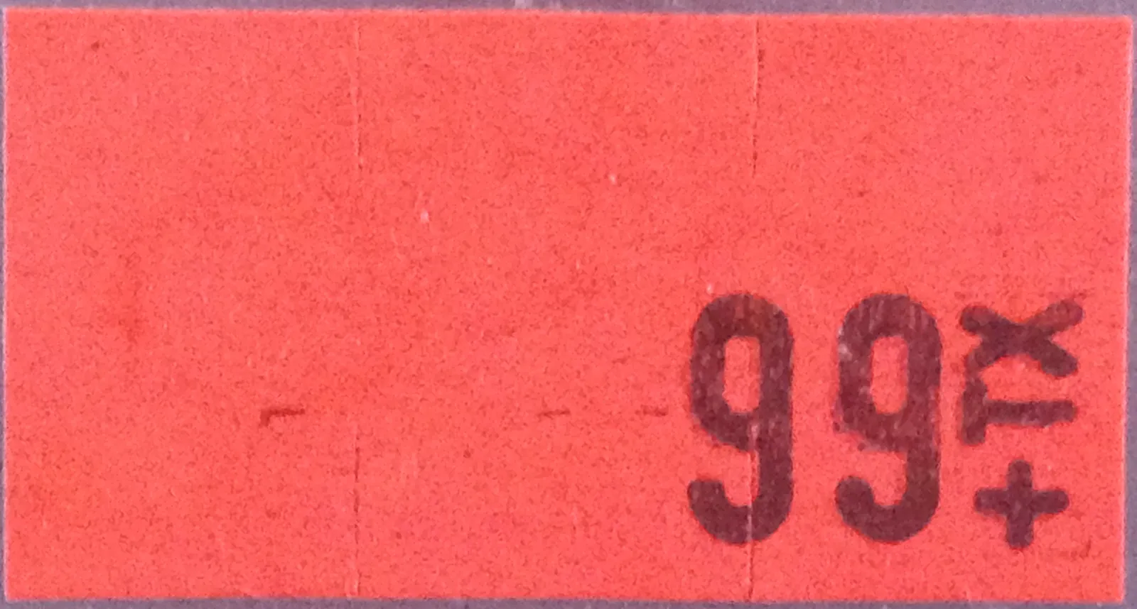 A bright red supermarket price sticker printed with 99 cents plus tax
