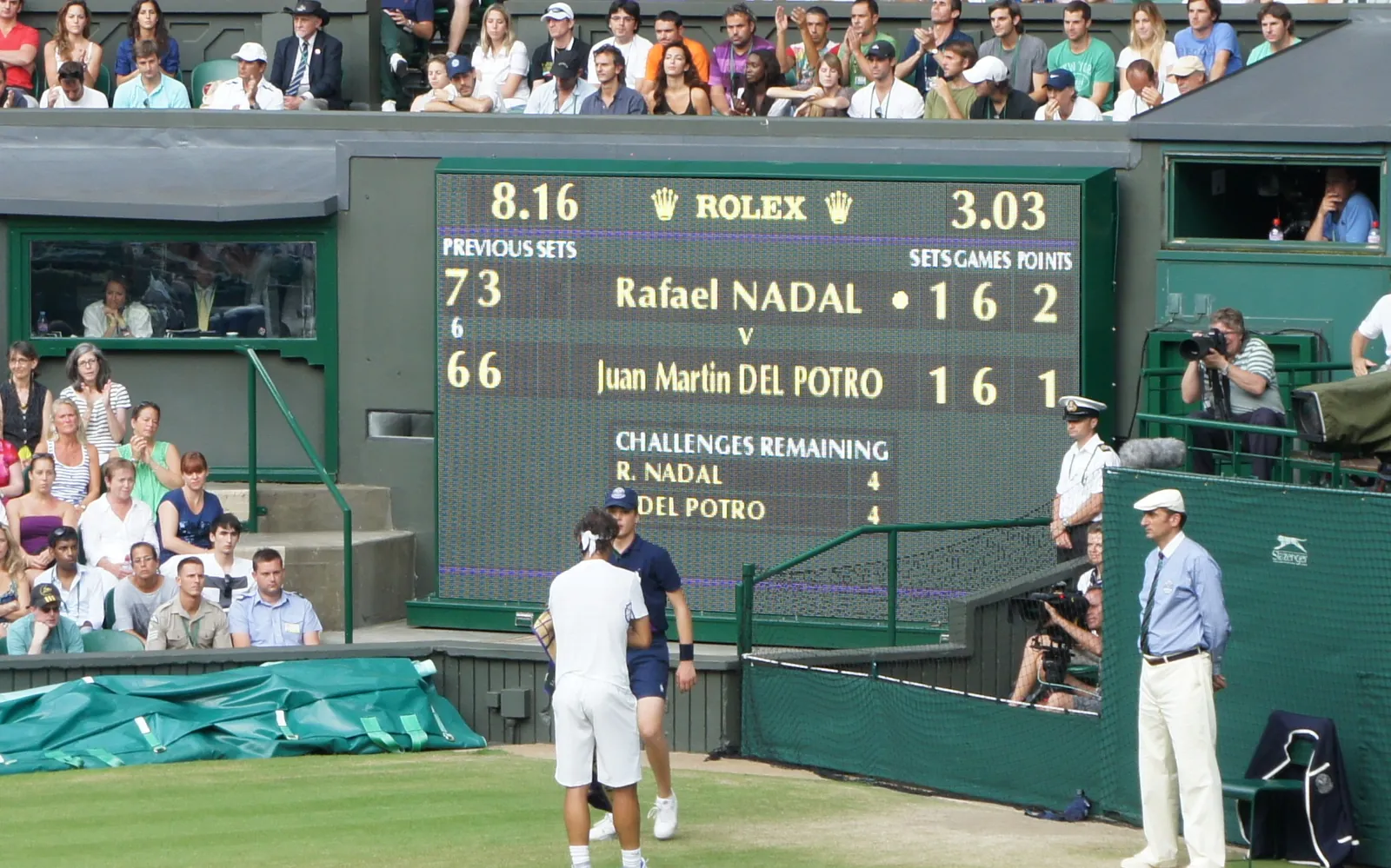 The Centre Court scoreboard at Wimbledon showing sets, games and points during a men's singles match